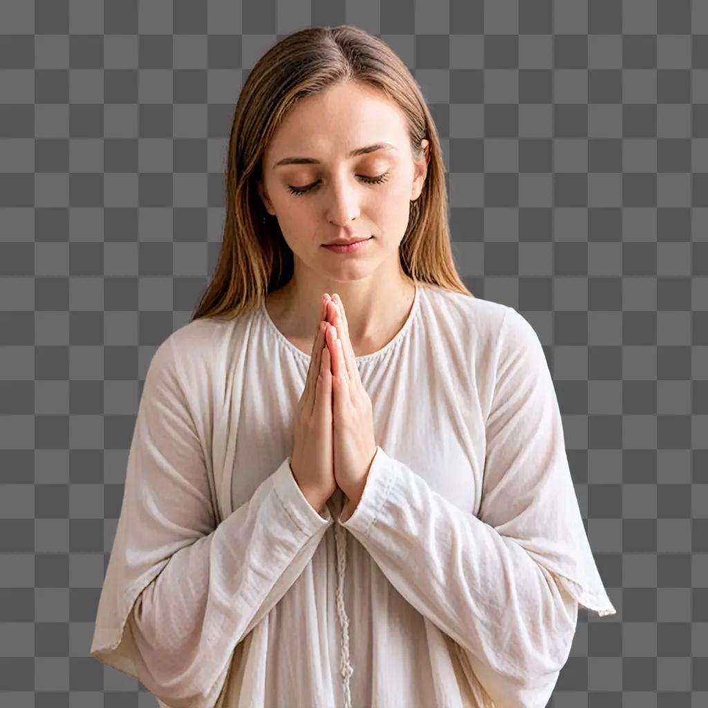 A woman praying with her hands folded in front of her face