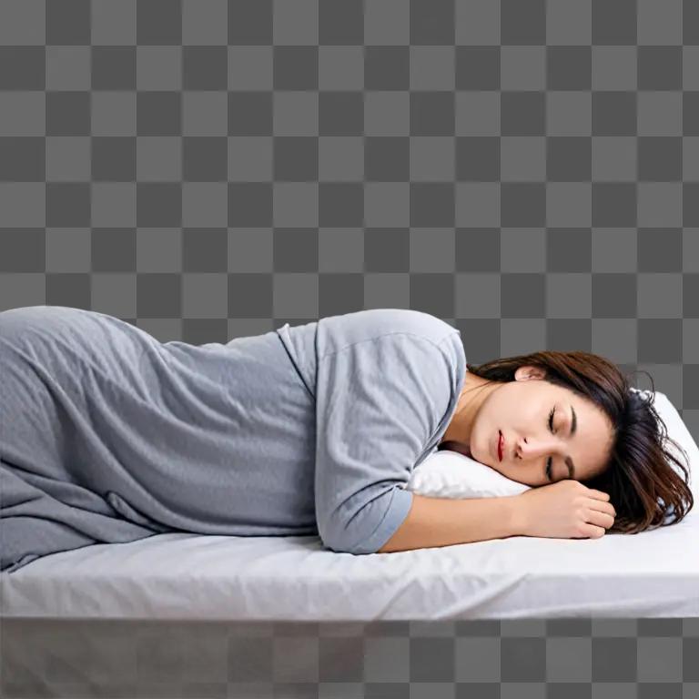 A woman sleeps in a gray outfit on a bed