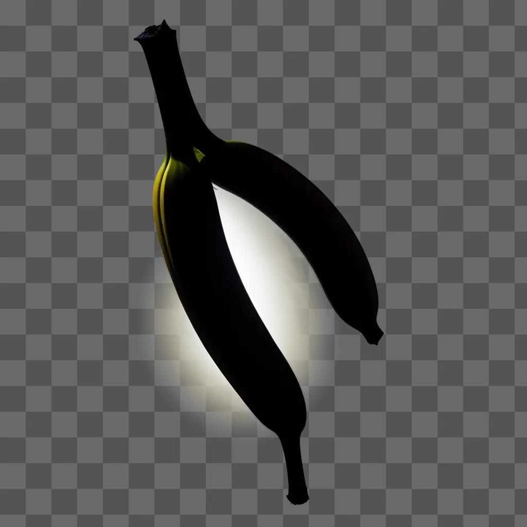 Black silhouette of a banana with yellow light