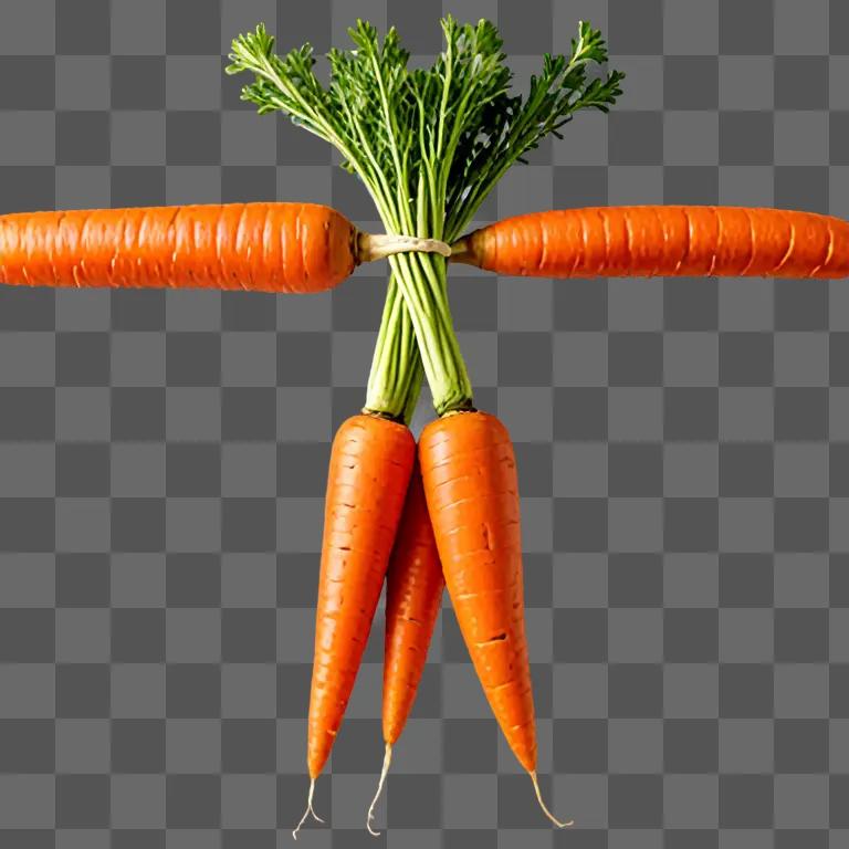 Four carrots with green stems on a light orange background