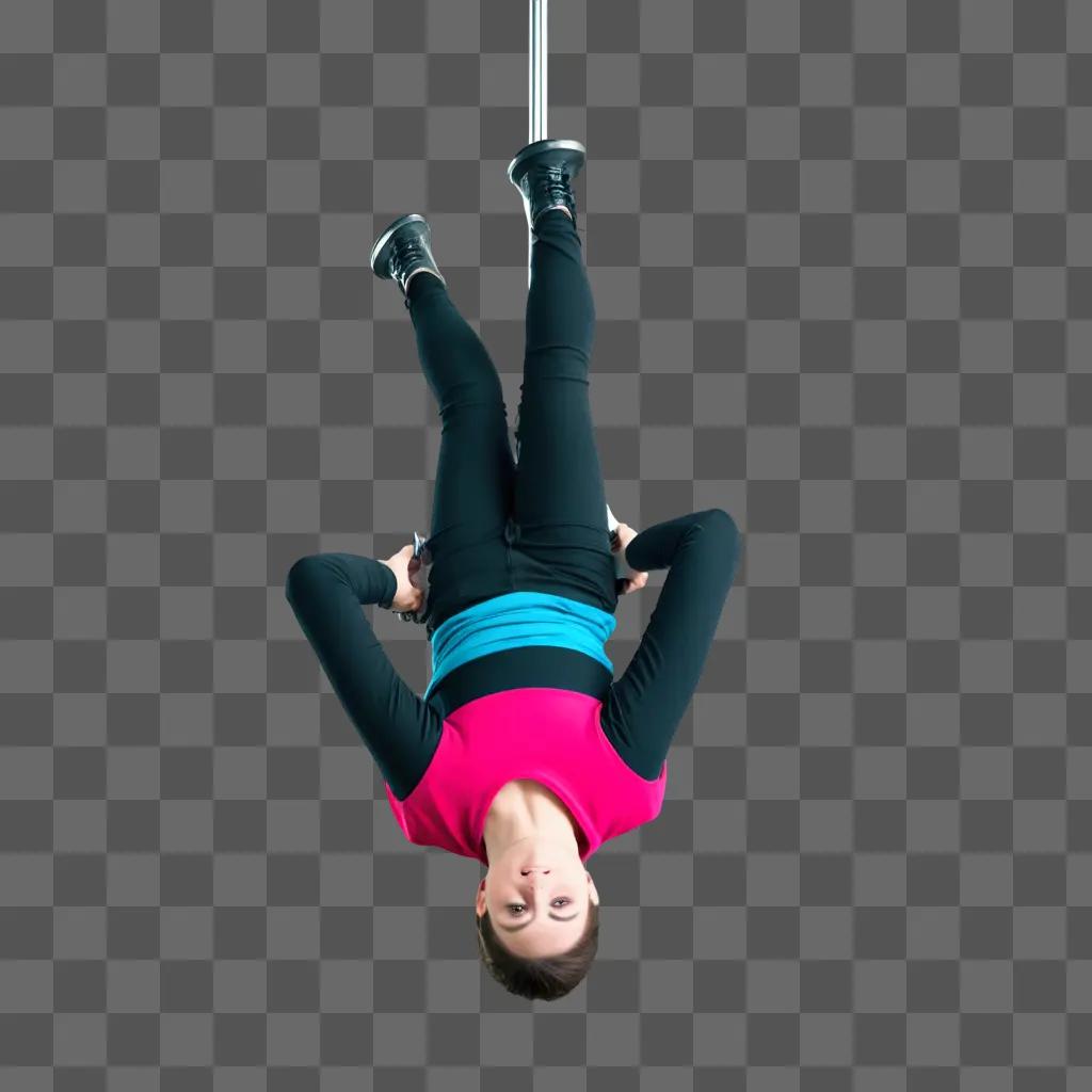 Hanging upside down from a pole with a black and pink outfit