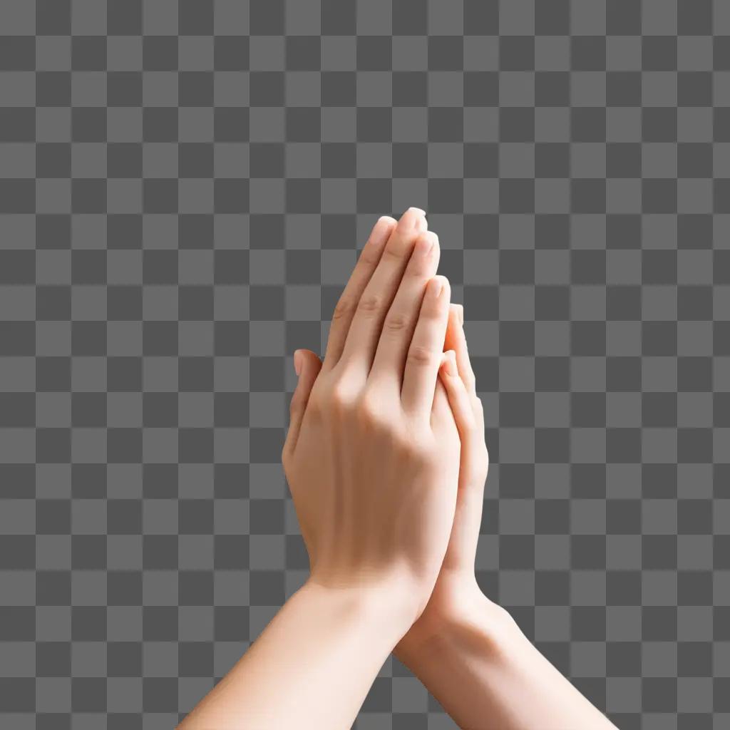 Praying hands with fingers touching on pink background