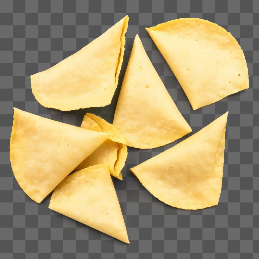 Several tortilla chips on a yellow background