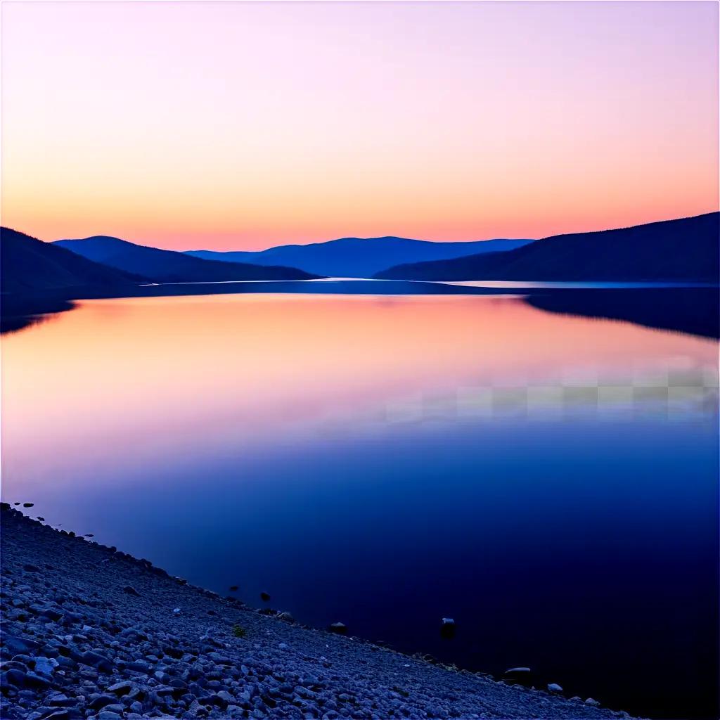 Sunrise over the calm lake, with mountains in the distance