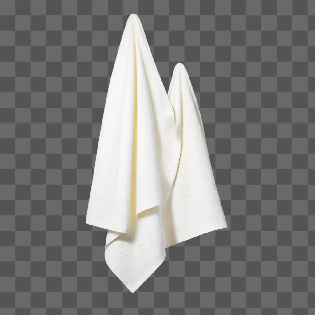 Towels hang against a white background