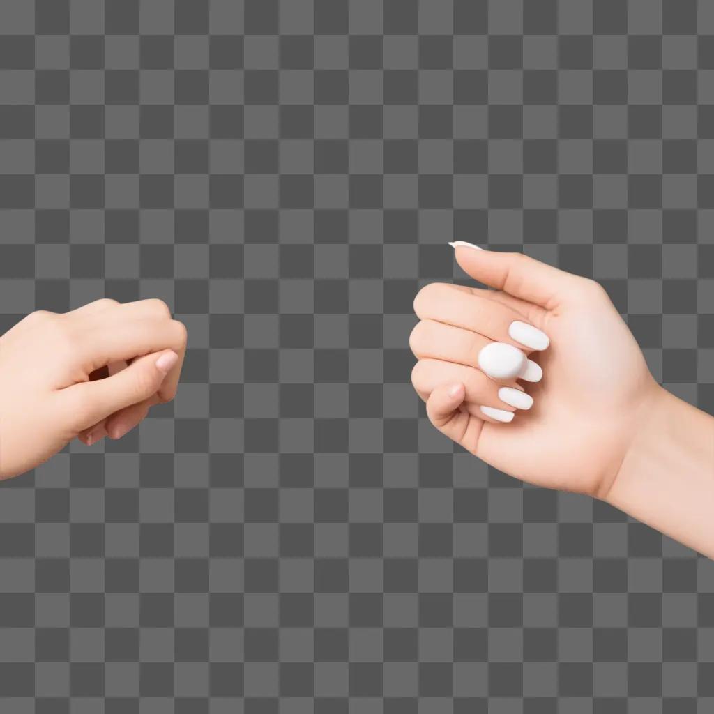 Two hands holding a small object on a pink background