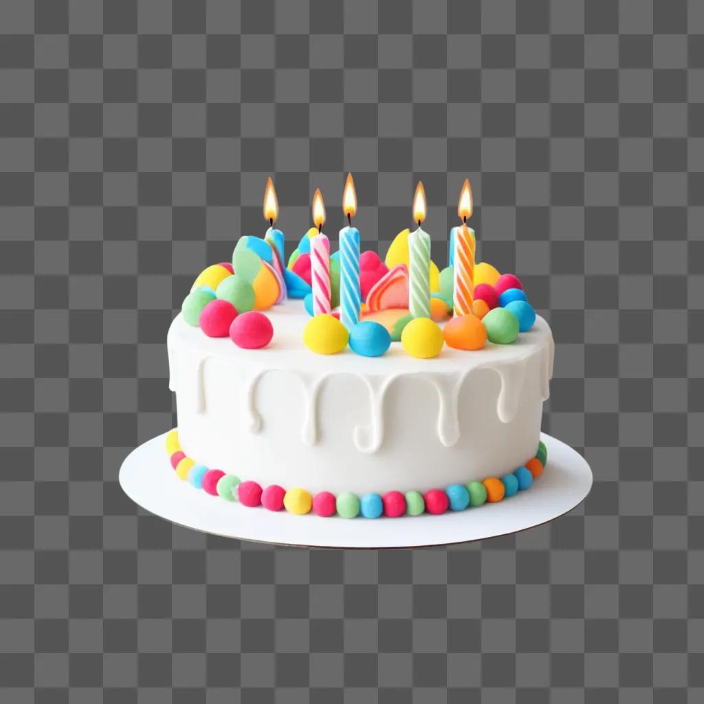 birthday cake with multicolored candles and candies on a white plate