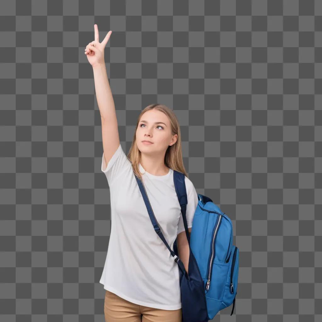 girl in a white shirt with a backpack raises her hand and makes a peace sign