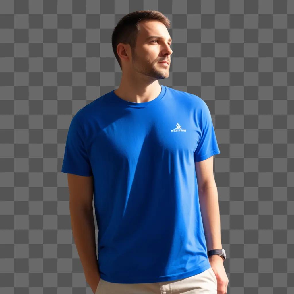 man in a blue t-shirt stands against a blue wall