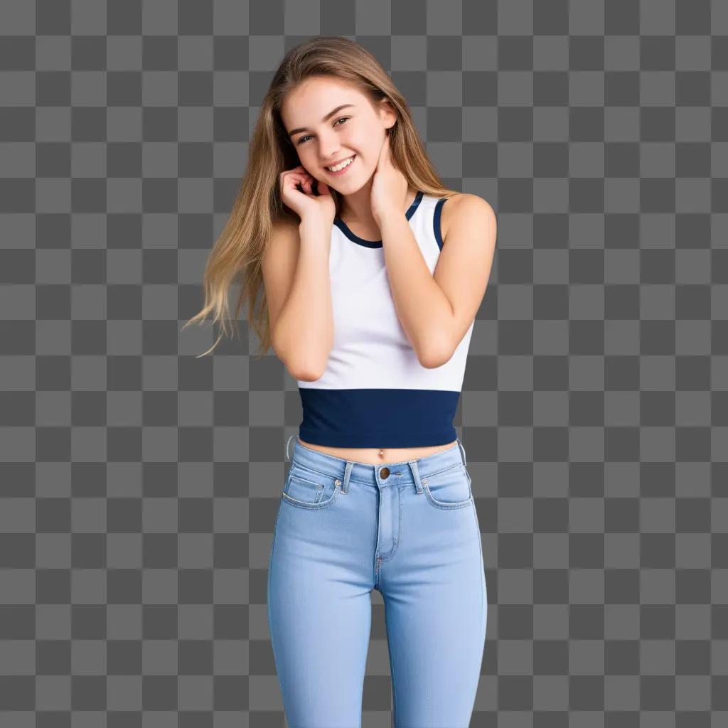 10代の女の子はタンクトップとジーンズでポーズをとります