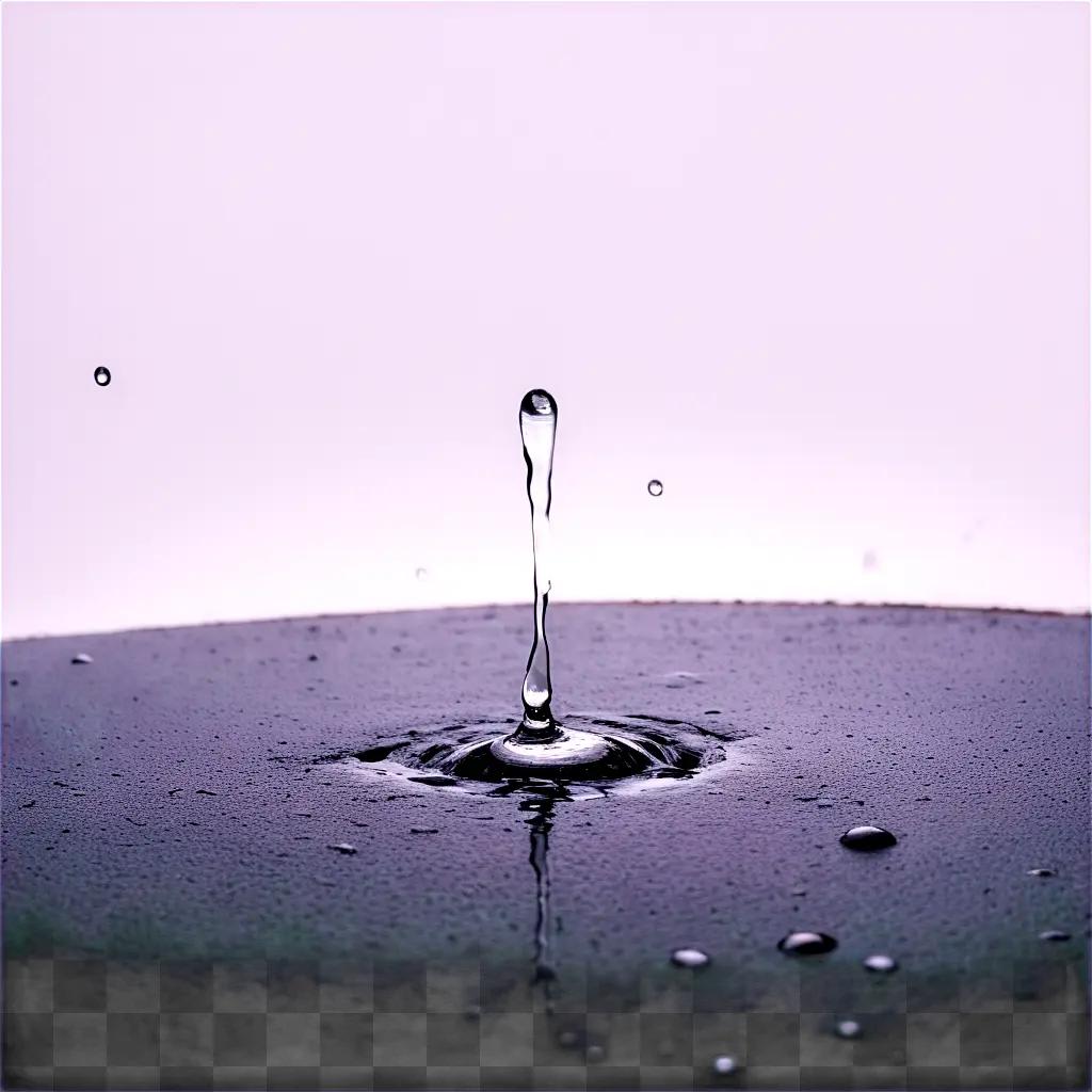 water droplet drips onto a black surface